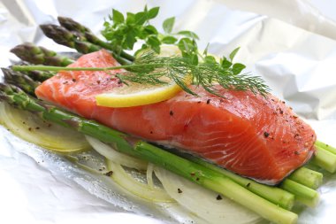 fresh salmon with asparagus in foil paper, ready for cooking