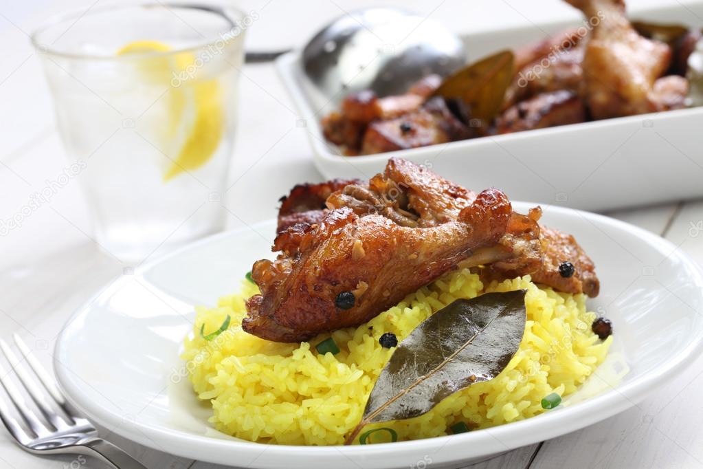 chicken and pork adobo over yellow rice, filipino food