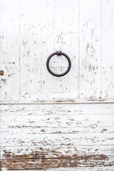 Weathered white wooden door with paint chipped and peeling. — Stock Photo, Image