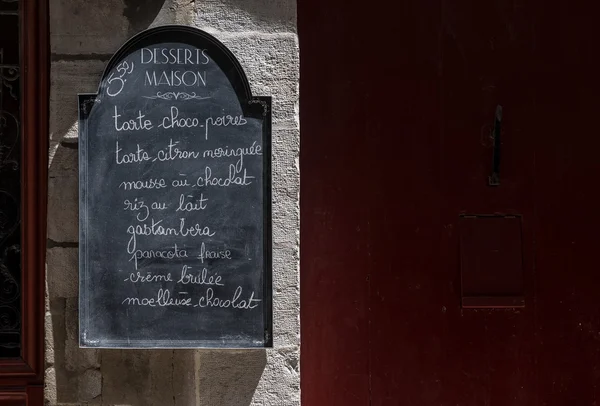 Sweets menu blackboard on a stone wall. — Stock Photo, Image