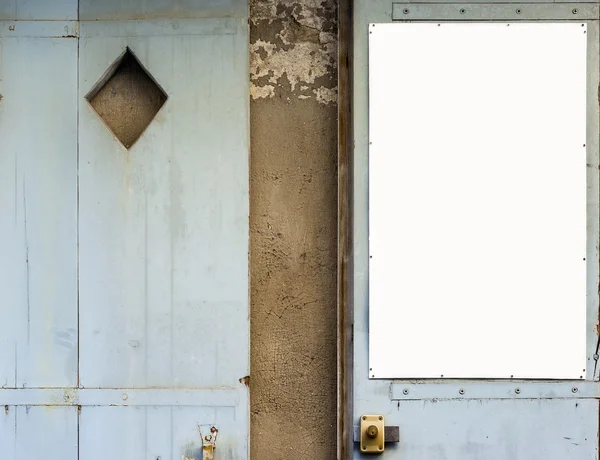 Antique blue wooden doors with a white panel in blank. — Stock Photo, Image