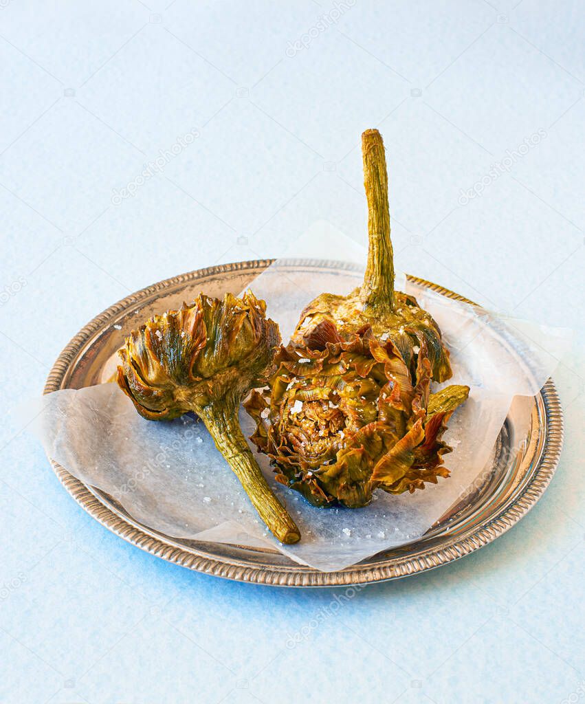 Roman fried artichokes Jewish style seasoned with flakes of kosher salt. Italian cuisine.