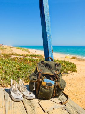 Backpacking traveller in a beach rest. Tavira island, Algarve. Portugal clipart