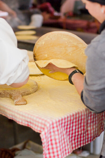 Woman Making talos, Tortilla than wraps txistorra.