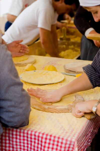 Woman Making talos, Tortilla than wraps txistorra.