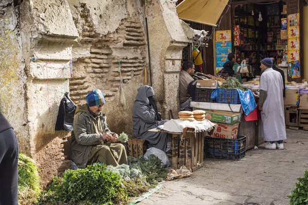 Man selling typical arabian aromatic herbs in a street of Morocc
