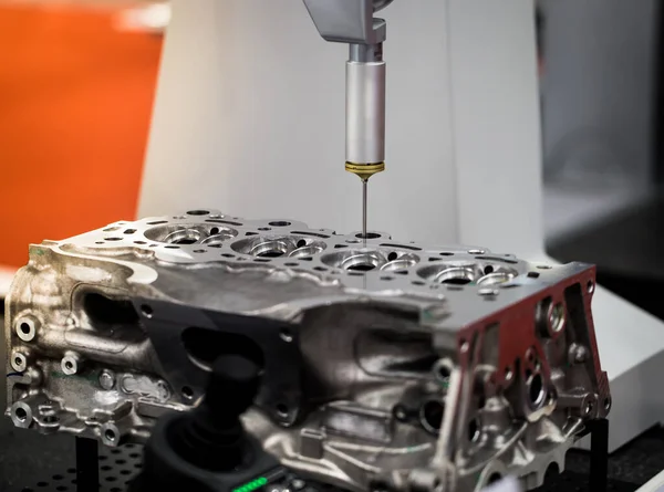 CMM Coordinate Measuring Dimension Machine inspecting engine part. Automotive industry