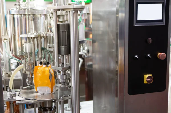 Food liquid nozzle packaging machine. Orange juice pouch filling machine. Food industry