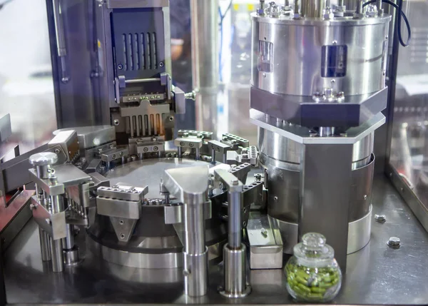 Capsule filling and packing machine in pharmaceutical manufacturing factory.