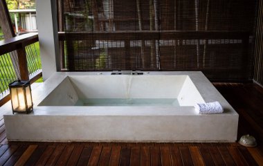 Terasta açık havuz küveti. Açık havada spa merkezi. Kulübenin balkonunda jakuzi.