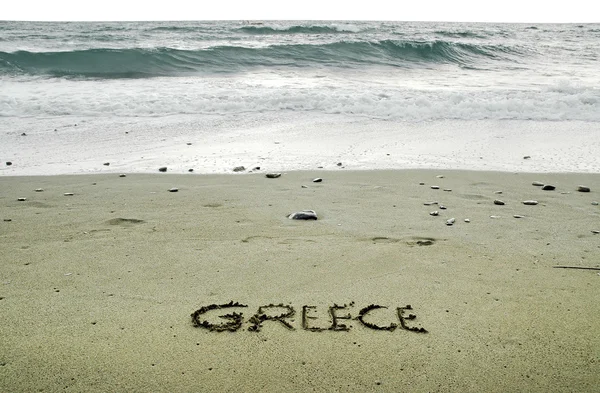 Griechenland in Sand am Strand geschrieben — Stockfoto