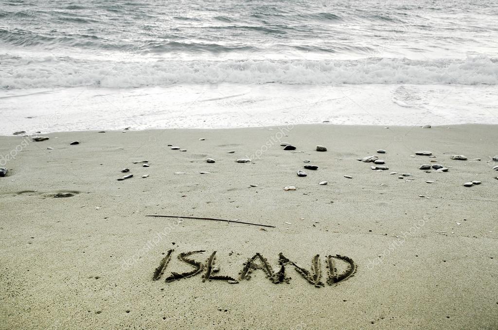 Island written in sand on the beach