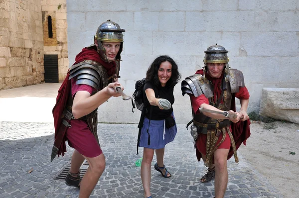 Men dressed as Roman soldiers posing with tourist — Stock Photo, Image