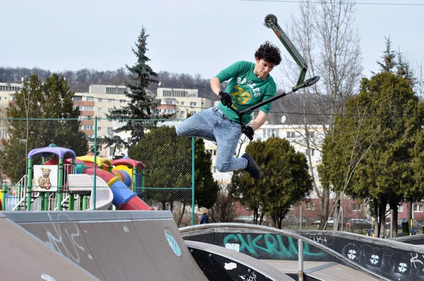 Молодой парень прыгает на скутере — стоковое фото