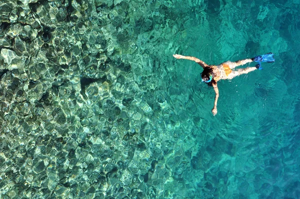 Giovane donna che fa snorkeling in mare poco profondo trasparente — Foto Stock