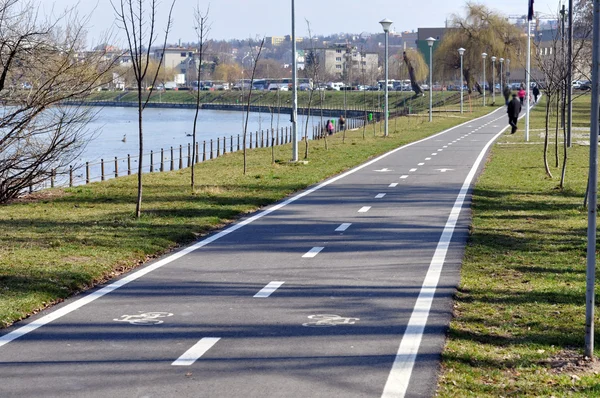 Bicycle road near a river Stock Picture