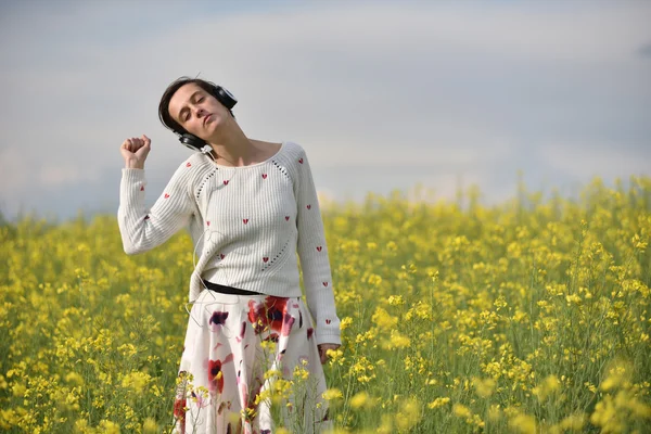 Чувственная женщина слушает музыку в наушниках на открытом воздухе — стоковое фото