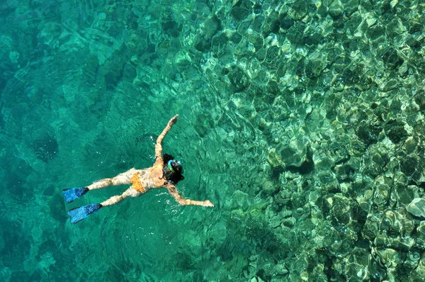 Jovem mulher snorkeling no mar raso transparente — Fotografia de Stock