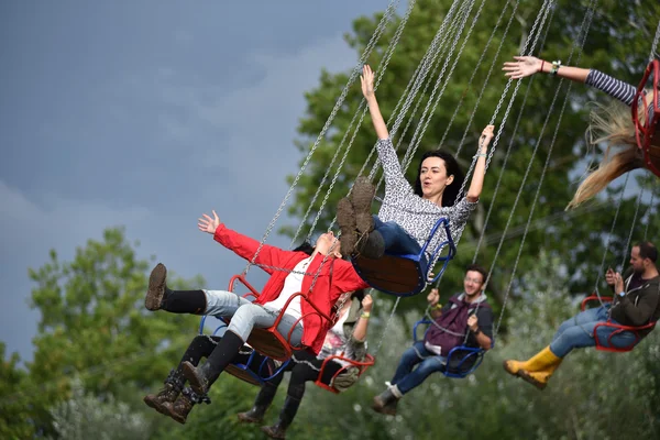 People in merry go round, swing ride, highland spinner — Stock Photo, Image