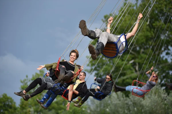 People in merry go round, swing ride, highland spinner — Stock Photo, Image