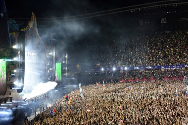 Smoke cannons emitting smoke on crowd at a concert clipart