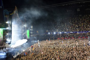 Smoke cannons emitting smoke on crowd at a concert