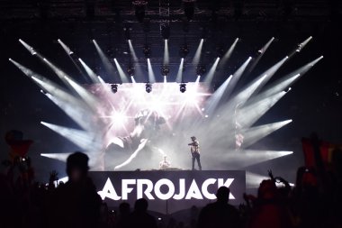 Dj Afrojack mixing on the stage