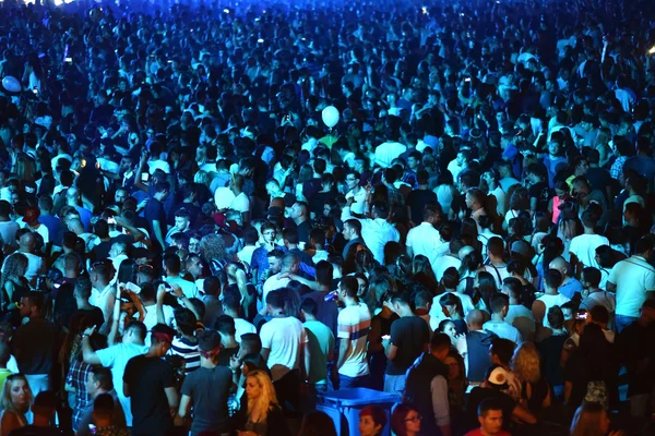 Crowd at a music concert, audience raising hands up — Stock Photo, Image