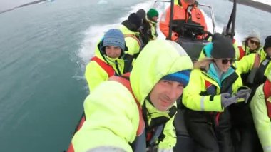 JOKULSARLON, ICELAND 22 Mayıs 2019: Jokulsarlon buzul gölünde yüzen buzdağları arasında tekne gezisine çıkan turist