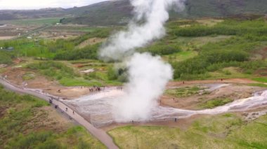 Suyun püskürmesi sırasında Strokkur geyiği üzerinde uçan, İzlanda, 4k hava aracı görüntüsü