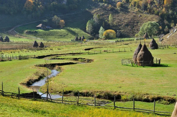 Paisagem de outono com palheiros em um vale — Fotografia de Stock