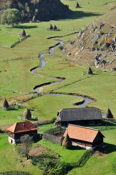 Осенний пейзаж с небольшой деревней в горах — стоковое фото