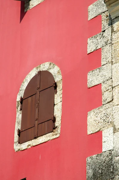 Janela velha em uma parede vermelha — Fotografia de Stock