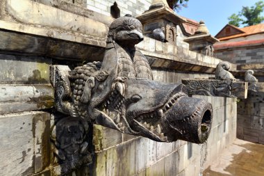 Carved stone public fountain in Pashupatinath, Nepal clipart