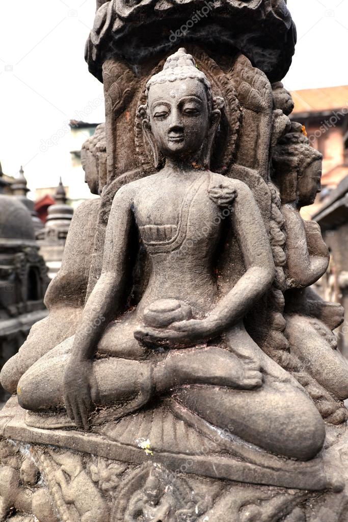 Stone statue of sitting Buddha in Swayambhunath. Nepal