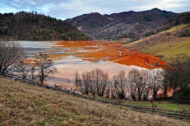  Pollution of a lake with contaminated water from a gold mine.  clipart