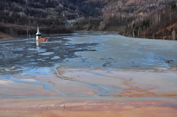 Abandoned church flooded by a lake full with chemical residuals. — Stock Photo, Image