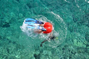 Snorkeler diving in the sea clipart