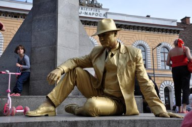 Street performer, living statue in golden costume clipart