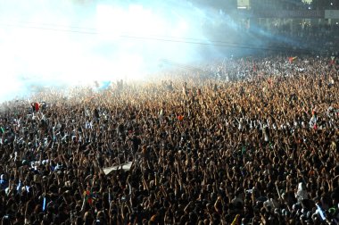 Crowd of people raising their hands at a concert