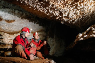 Spelunkers in a cave clipart