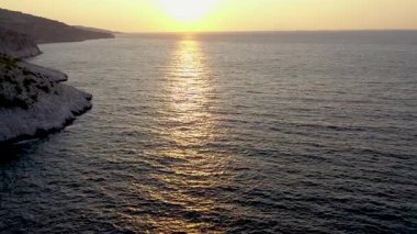 Aerial slow motion view calm sea waves washing the shoreline. Mediterranean sea, Greece by drone