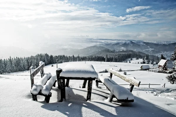 Table and bench covered by fresh snow after blizzard — Stock Photo, Image