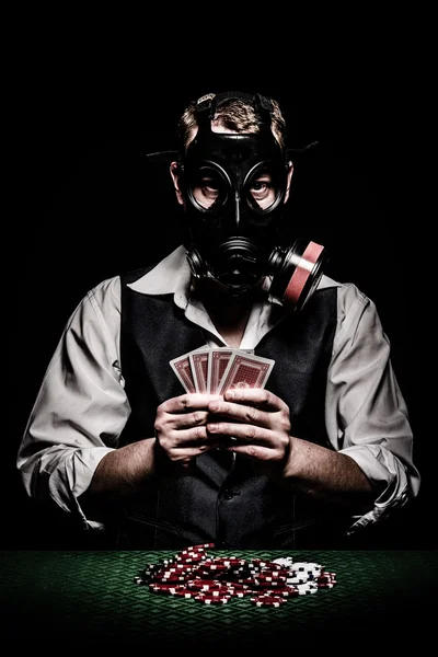 Poker player with a gas mask on his head