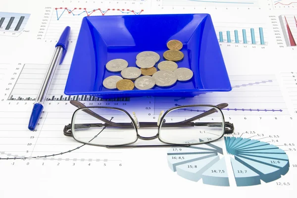 Business-stilleben av en penna, Glasögon, diagram, mynt i en pl — Stockfoto