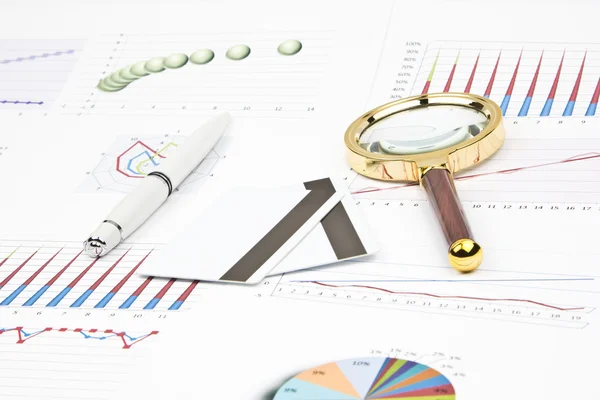 Business-stilleven van een diagram, Vergrootglas, pen, creditcard — Stockfoto
