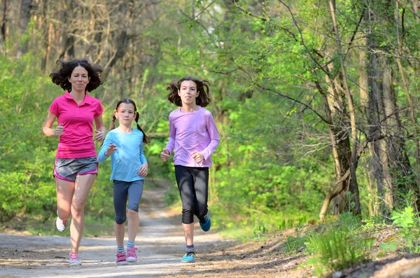 Aile spor, mutlu etkin anne ve açık havada jogging, ormanda koşu çocuklar — Stok fotoğraf