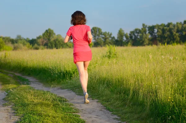 Woman runner jogging on trail outdoors, spring running and exercising — Stock Photo, Image