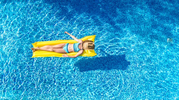 スイミングプールでリラックスした女の子 インフレータブルマットレスで泳ぐ子供 家族の休暇 トロピカルホリデーリゾート 上空からの空中ドローンビューで水を楽しむ — ストック写真