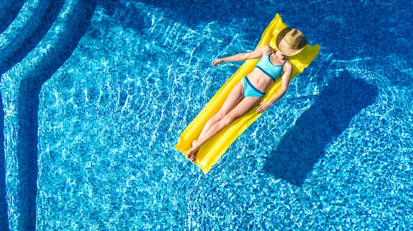 スイミングプールでリラックスした女の子 インフレータブルマットレスで泳ぐ子供 家族の休暇 トロピカルホリデーリゾート 上空からの空中ドローンビューで水を楽しむ — ストック写真